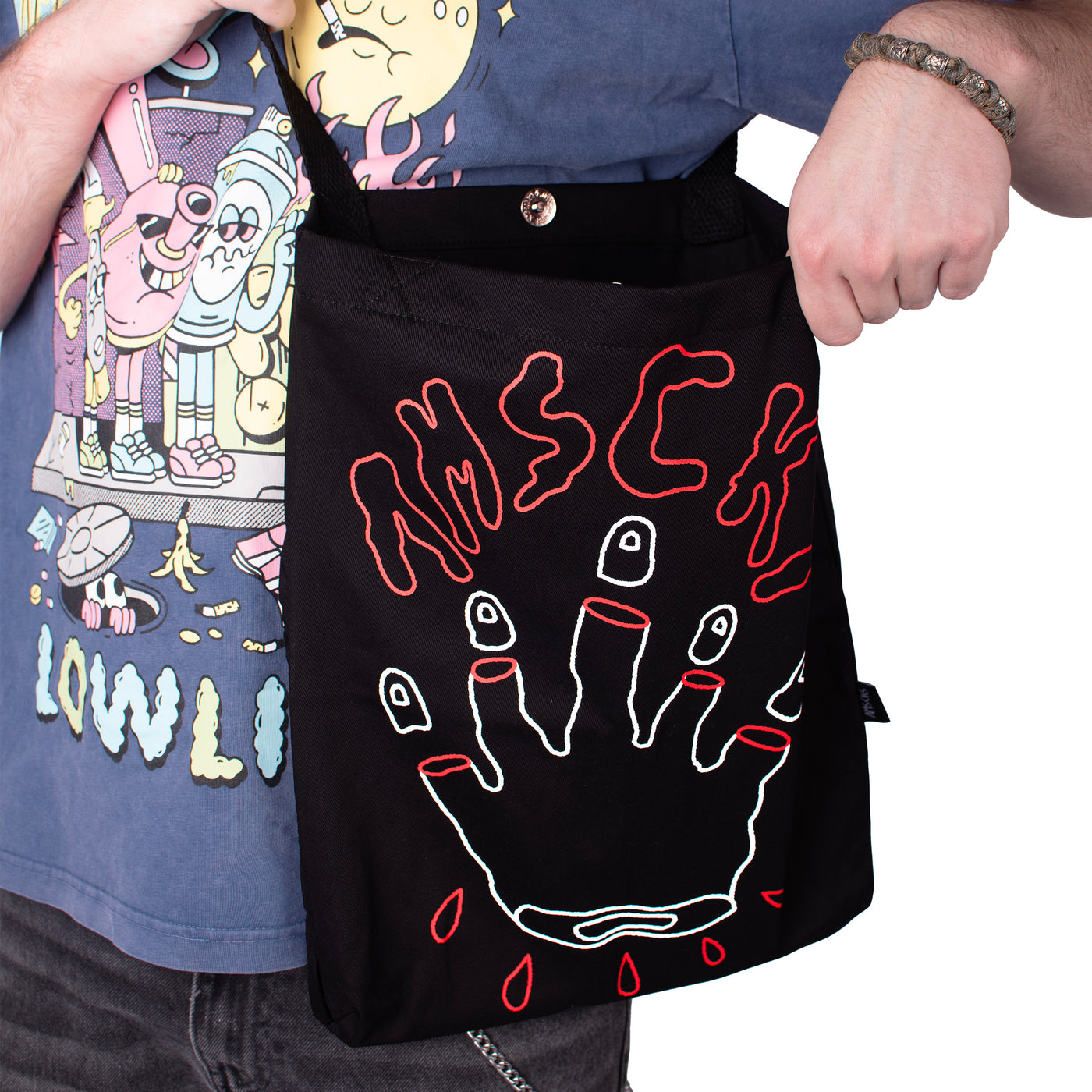 Person showing cool alternative tote bag with surreal edgy hand design with cut fingers american socks