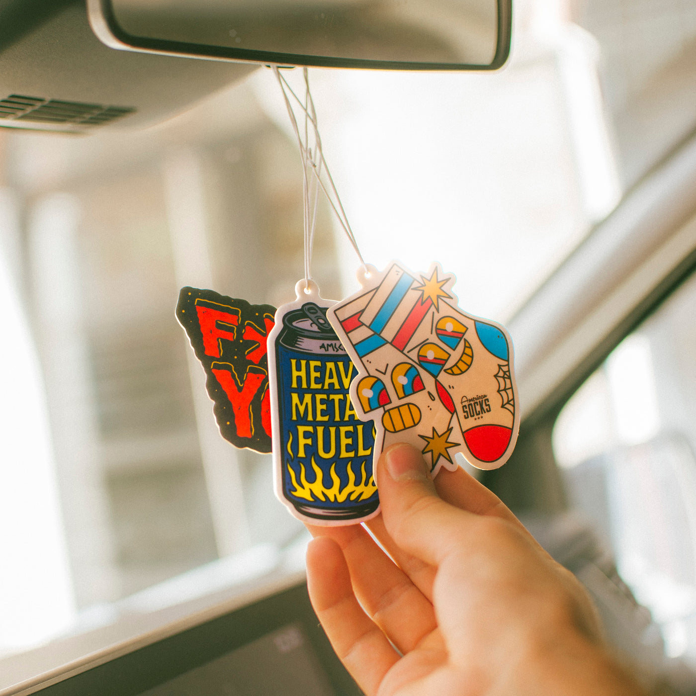 Alternative style car air fresheners hanging from rearview mirror american socks