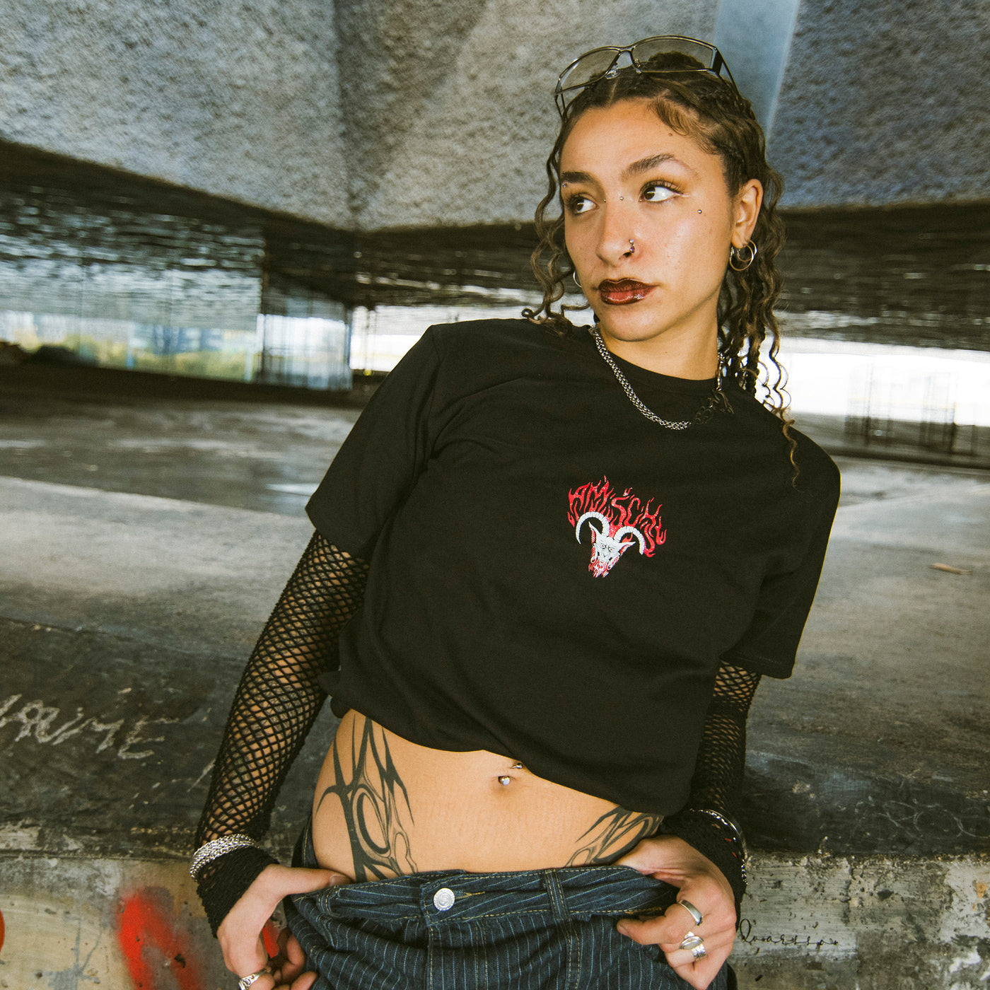 Alternative woman posing while wearing cool punk clothing by american socks