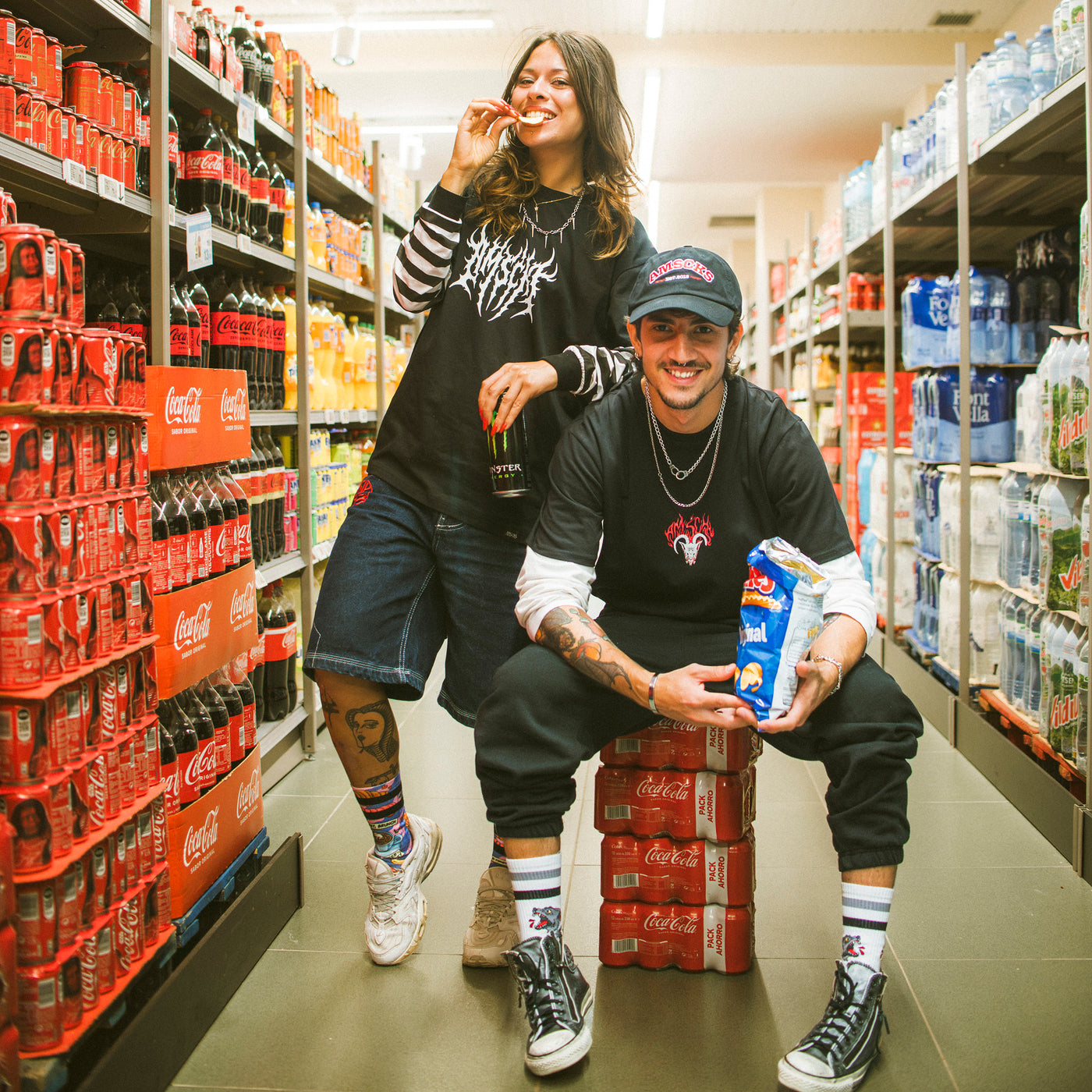 Man and woman wearing skate streetwear clothing in a supermarket aisle 