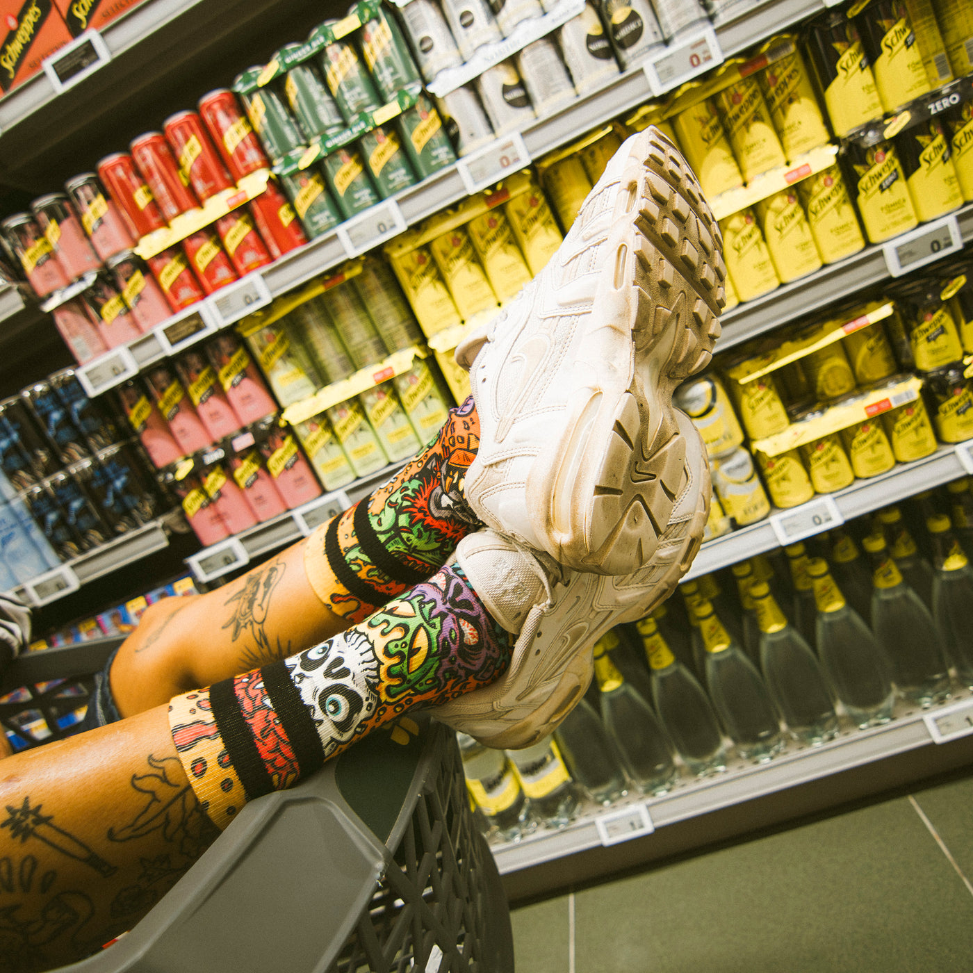 Fun psychedelic monster socks worn by a person in a supermarket american socks