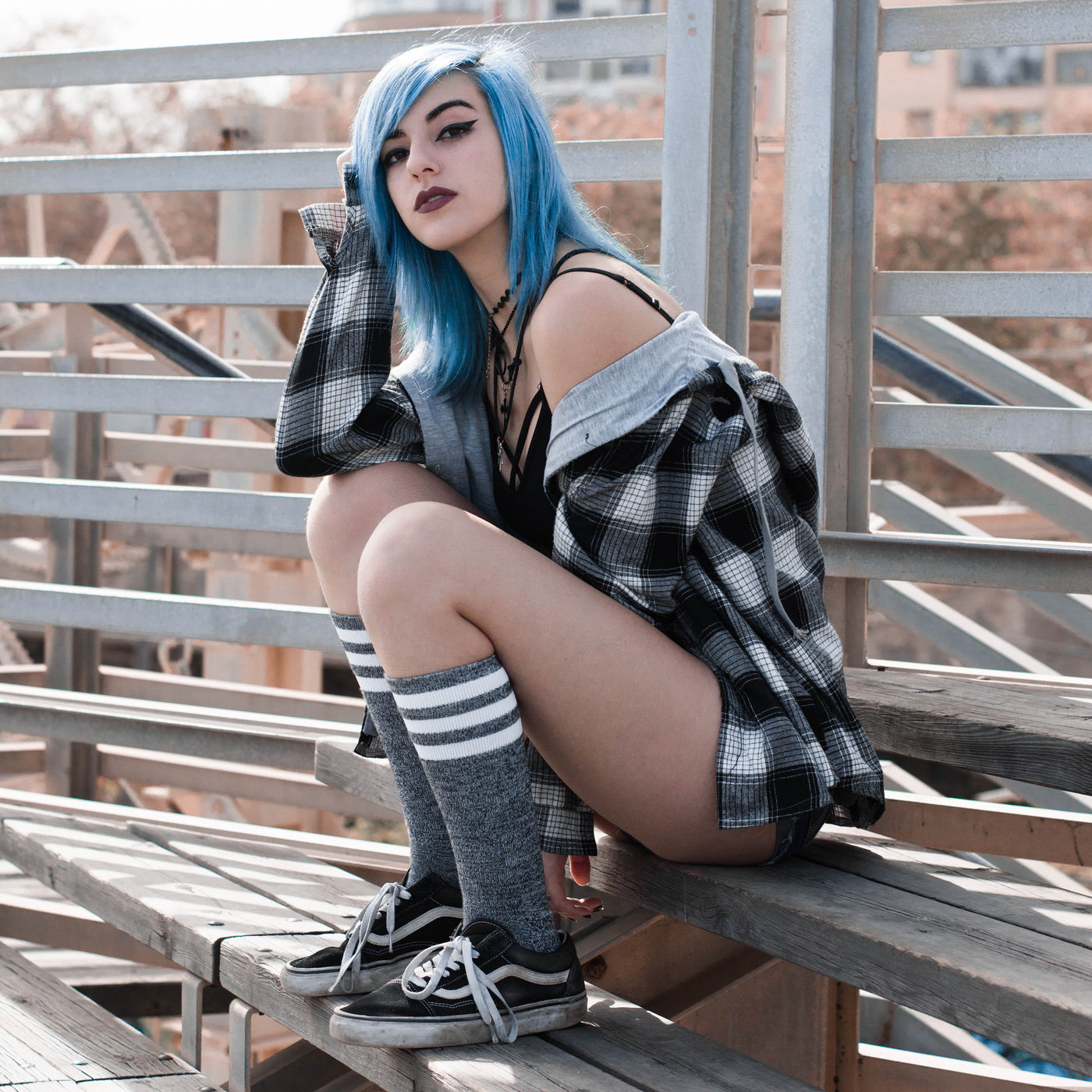 Alternative girl sitting on bench using gray retro knee high socks american socks