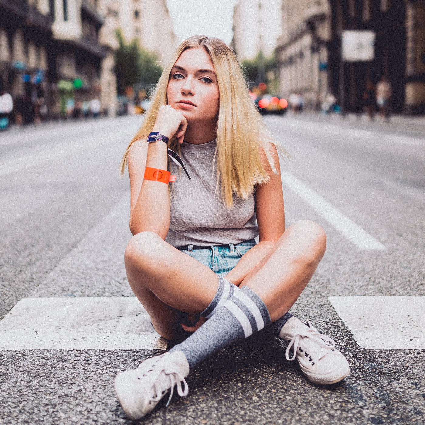 Girl sitting on the street wearing gray crew socks american socks