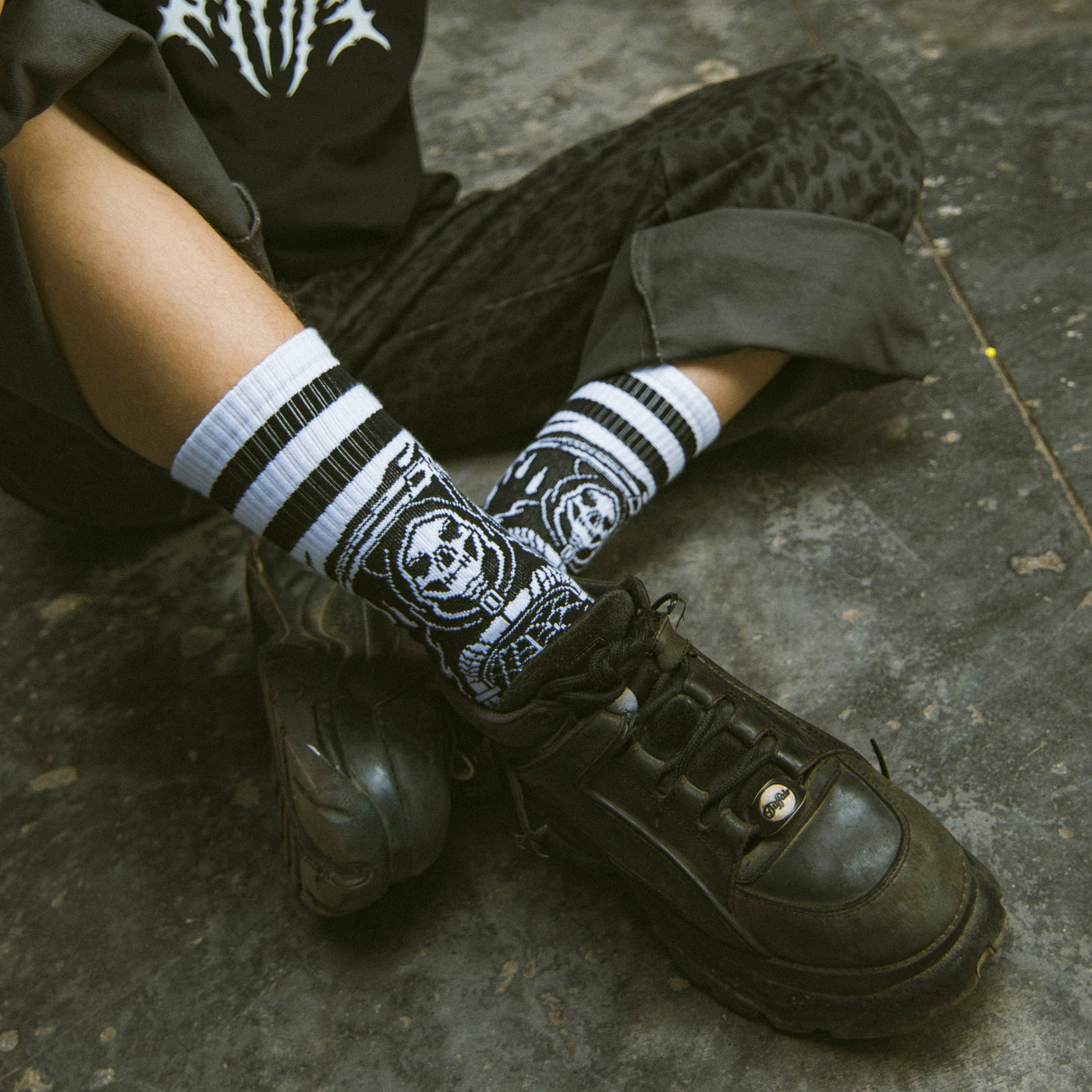 Person wearing cool skate socks with grim reaper illustration by american socks